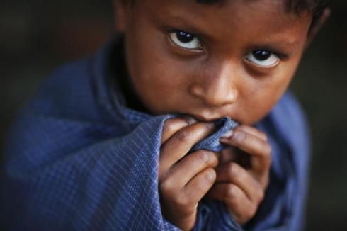 604A Rohingya Muslim boy wraps himself with a blanket at a camp for people displaced by violence, near Sittwe in northwest Myanmar